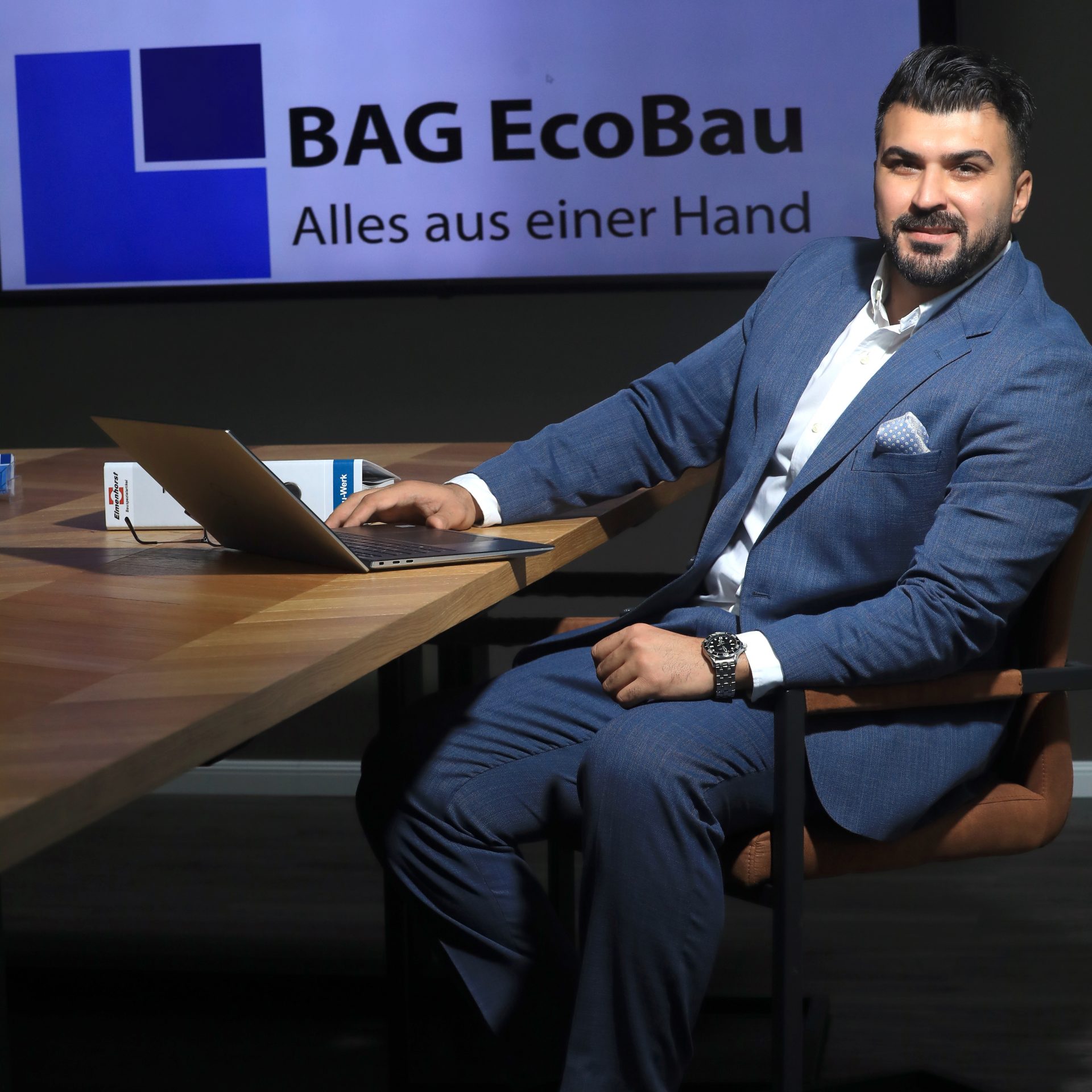 Side view of unrecognizable male in hoodie building brick wall while working on construction site in city